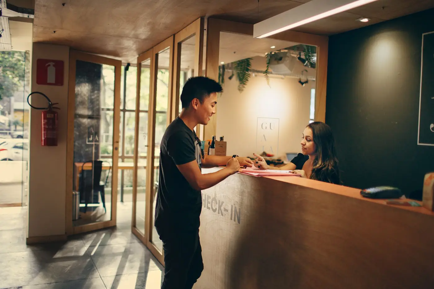 Gast checkt in bij de balie van een hotel