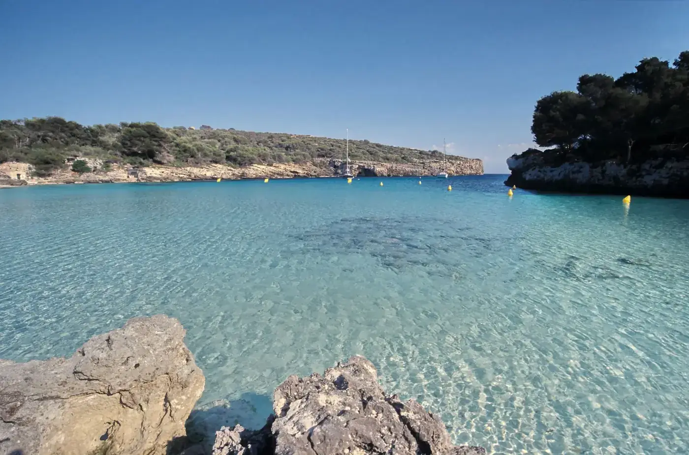 Crystal clear waters of a picturesque cove in Minorca, Balearic Islands.