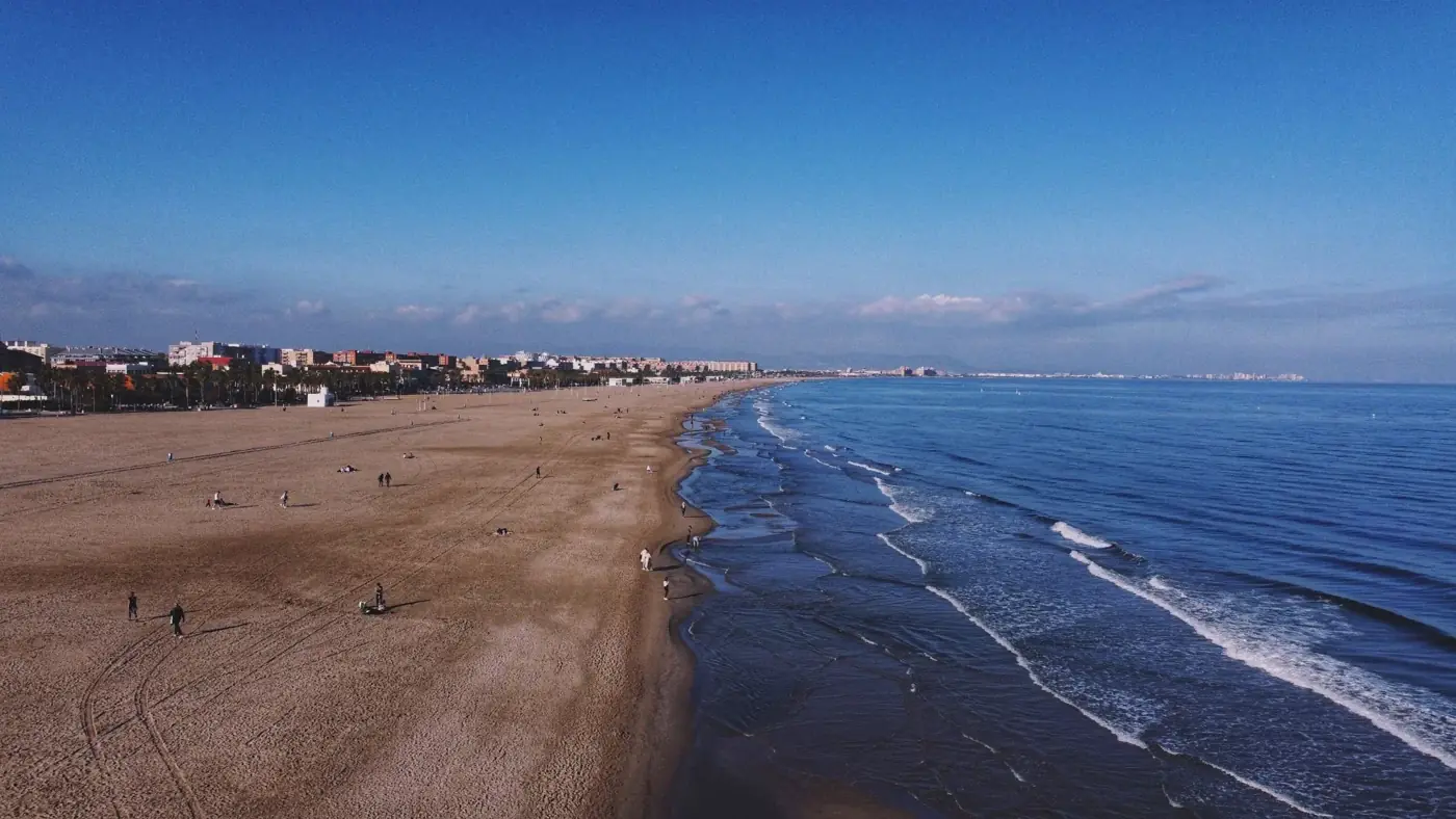 Stunning aerial view of Valencia's coastline, with beach and cityscape, capturing the serene seaside beauty.