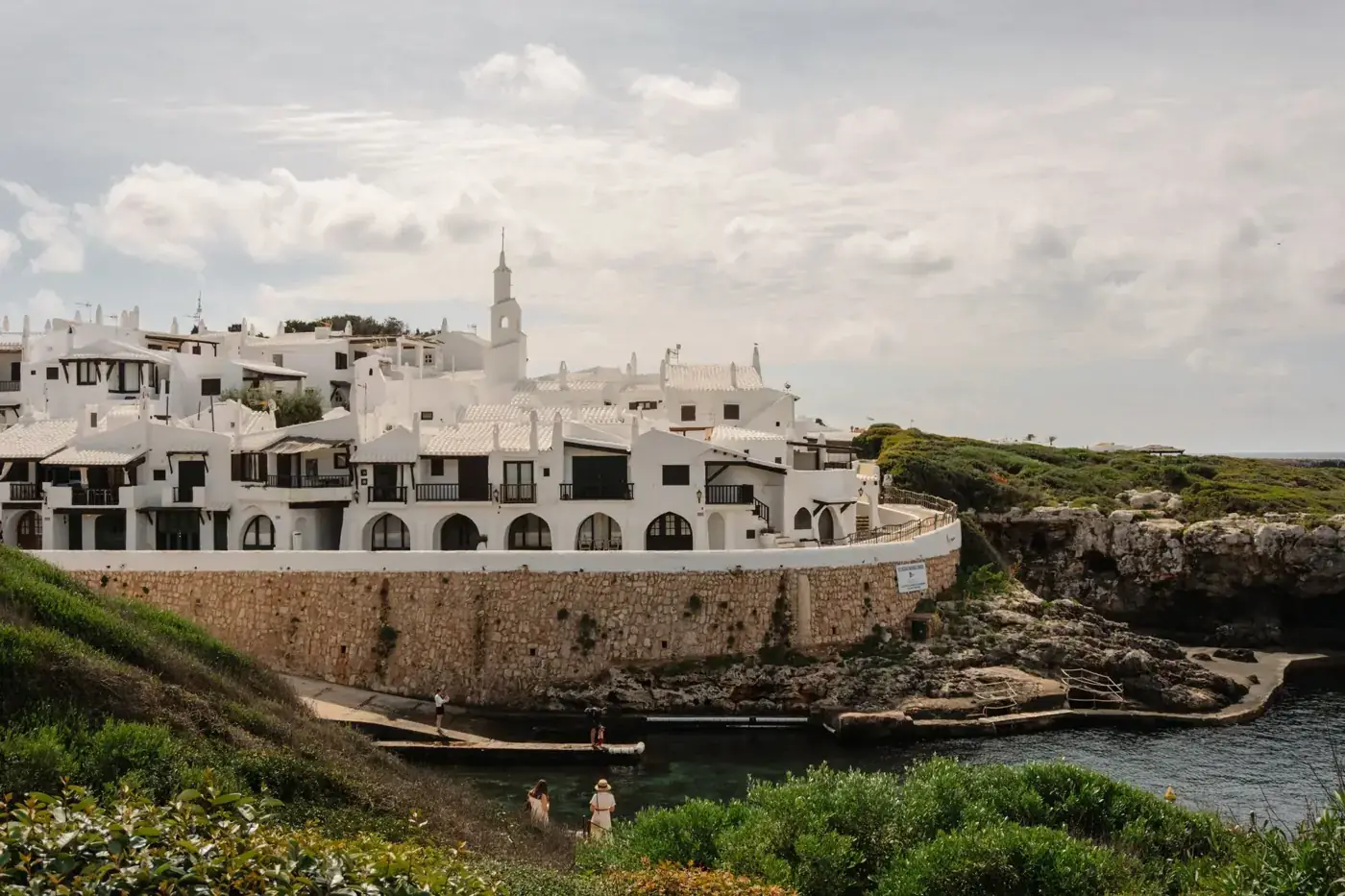 Charming white buildings along the coast in Ciutadella de Menorca, Spain.