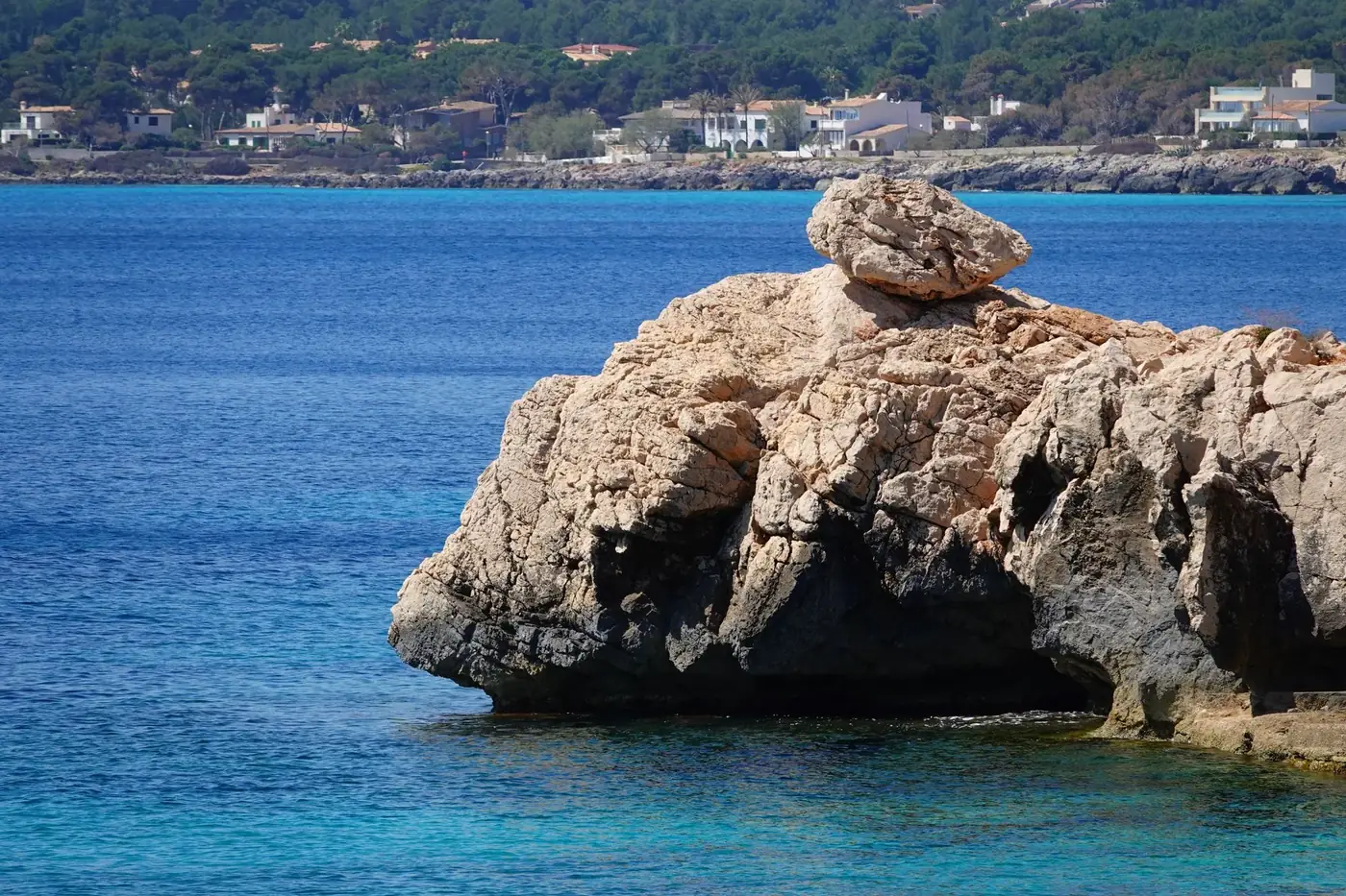 Beautiful rock formation on the seashore with blue sea in Cala Rajada, Spain.