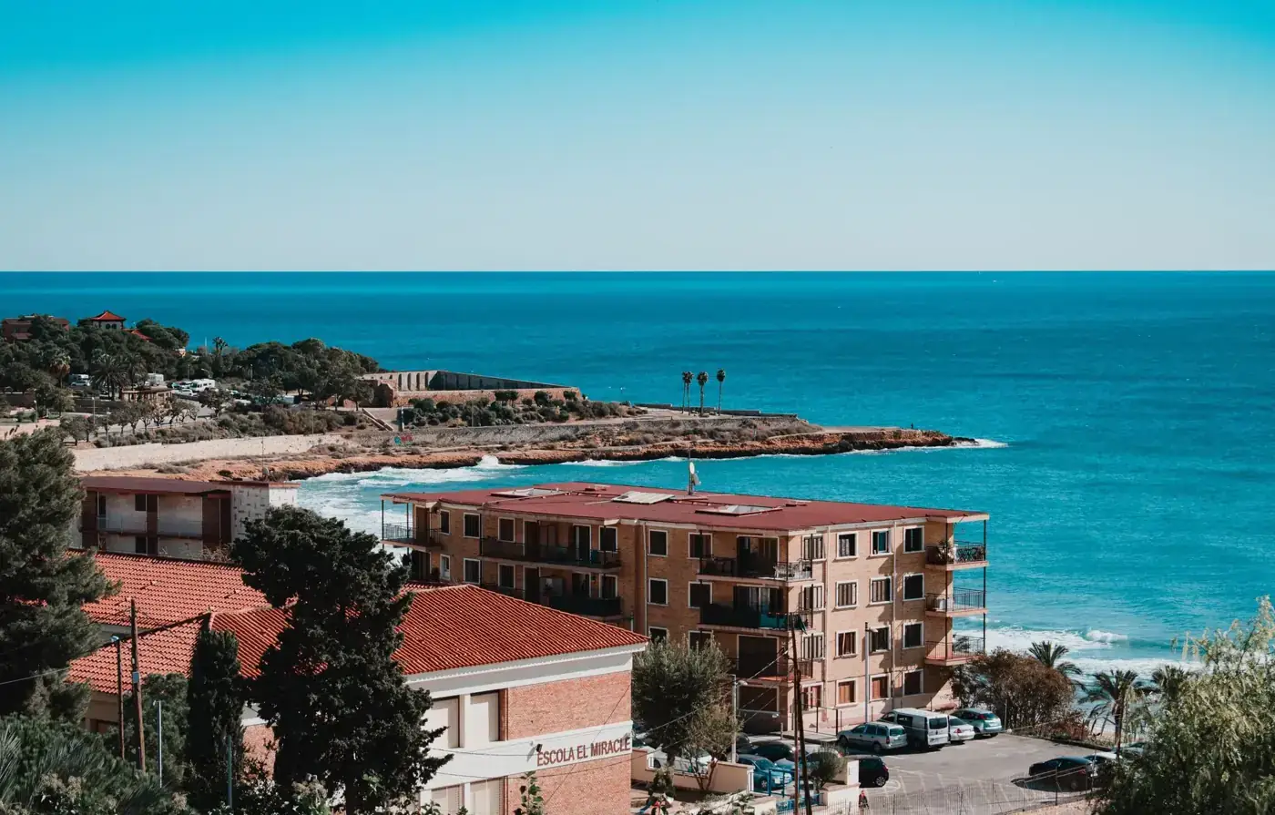 Aerial view of Tarragona's stunning coastline with clear blue skies and Mediterranean Sea.