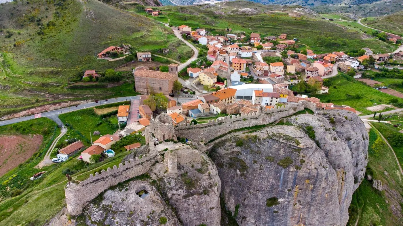 Discover the historic Clavijo Castle and village, captured in a stunning aerial view.