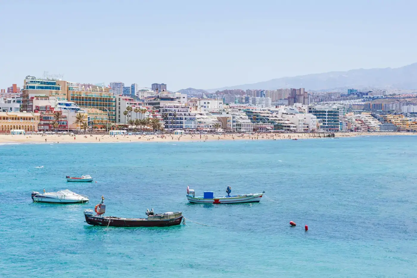 Stunning seaside view of Las Palmas with boats and city skyline.