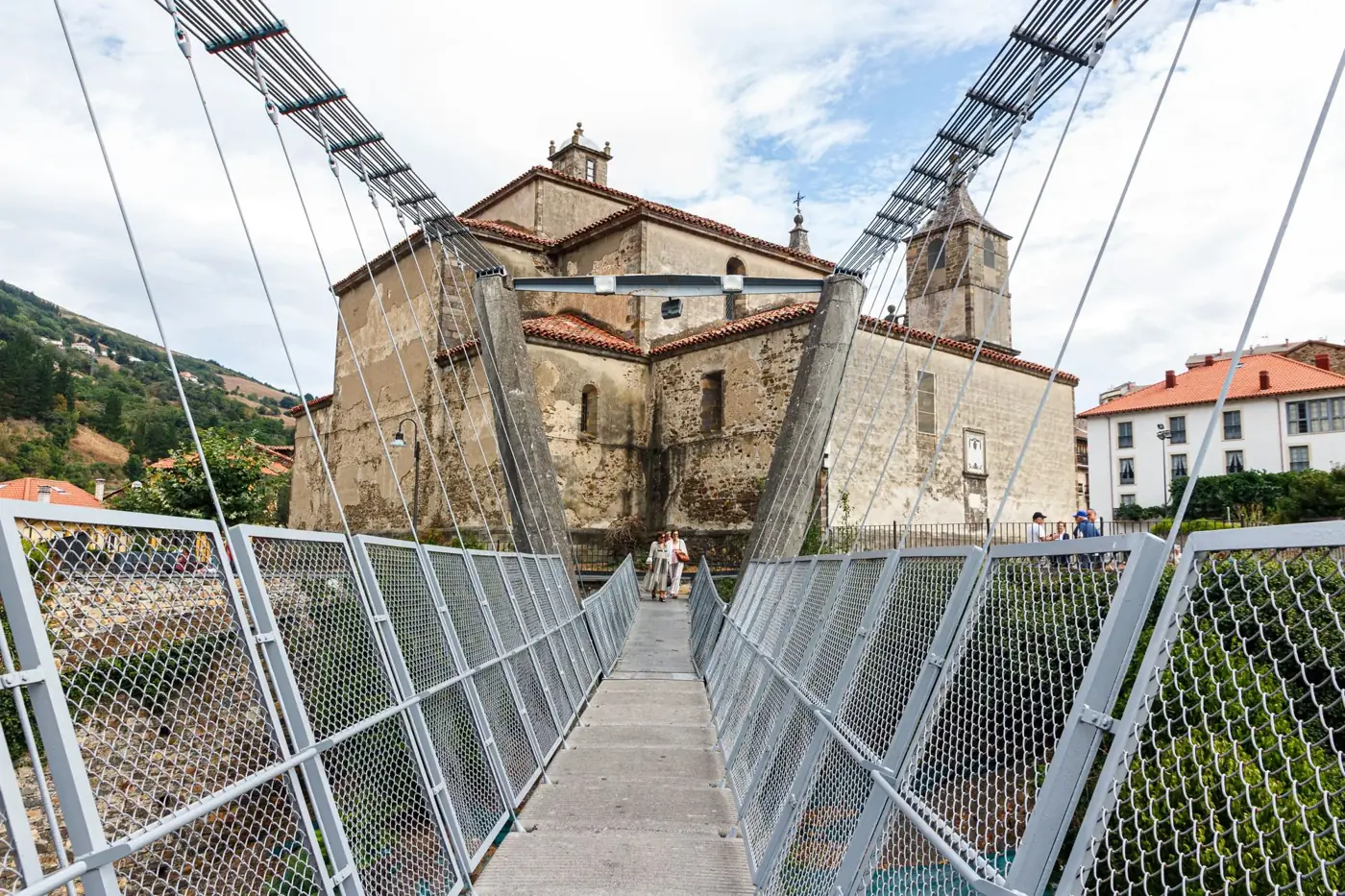 Explore the historic church and footbridge in Cangas del Narcea, Asturias, Spain.