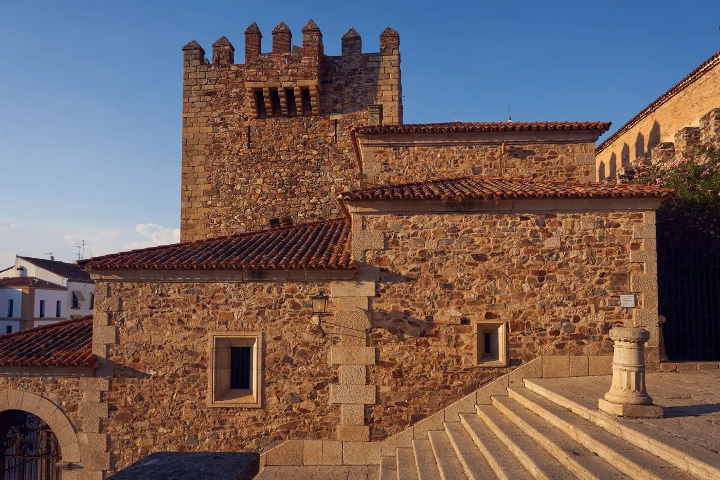 Stunning capture of medieval stone architecture illuminated by the golden sunset light.