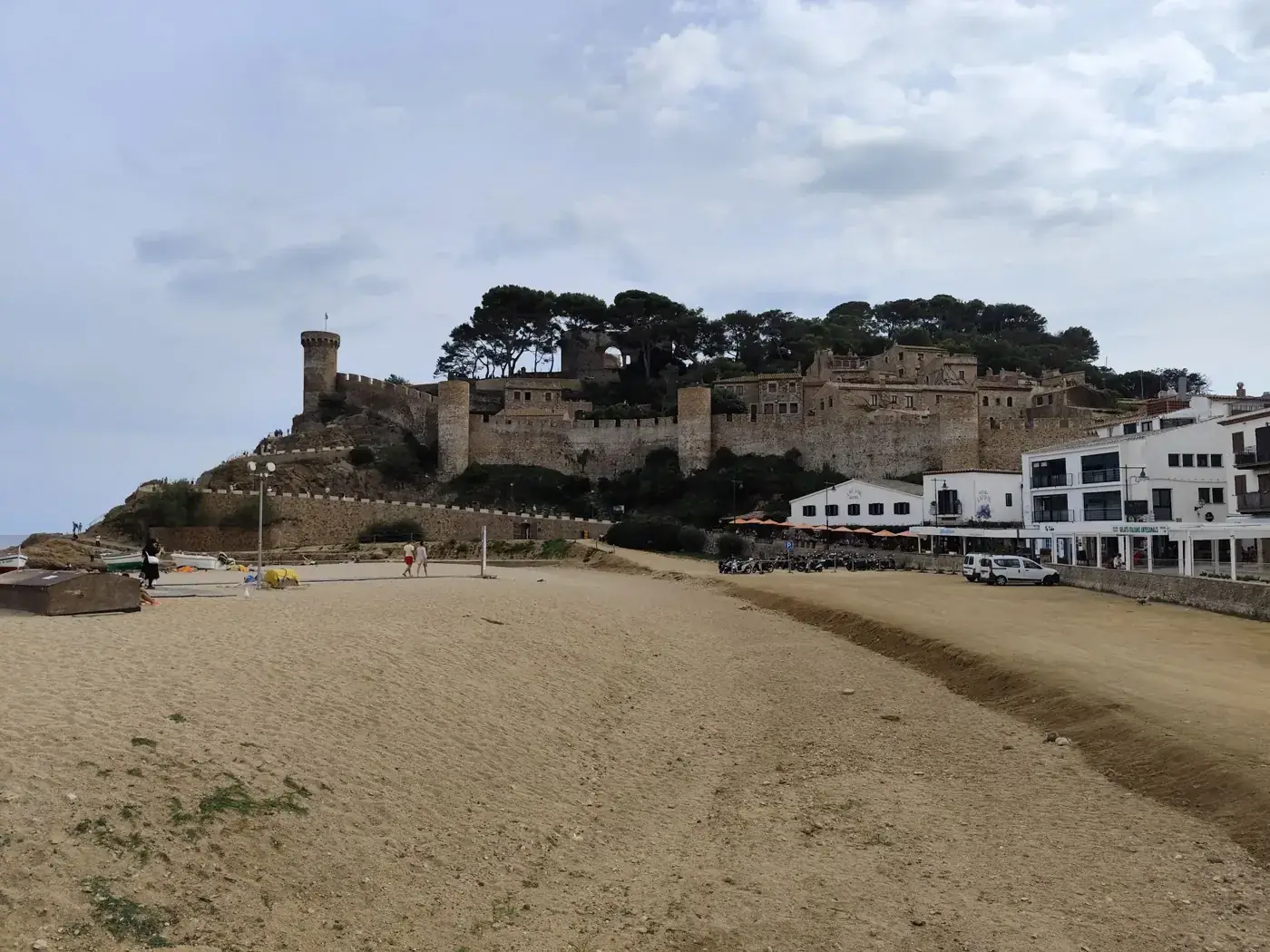 A picturesque view of Tossa de Mar's historic fortress and beach in Catalunya, Spain.