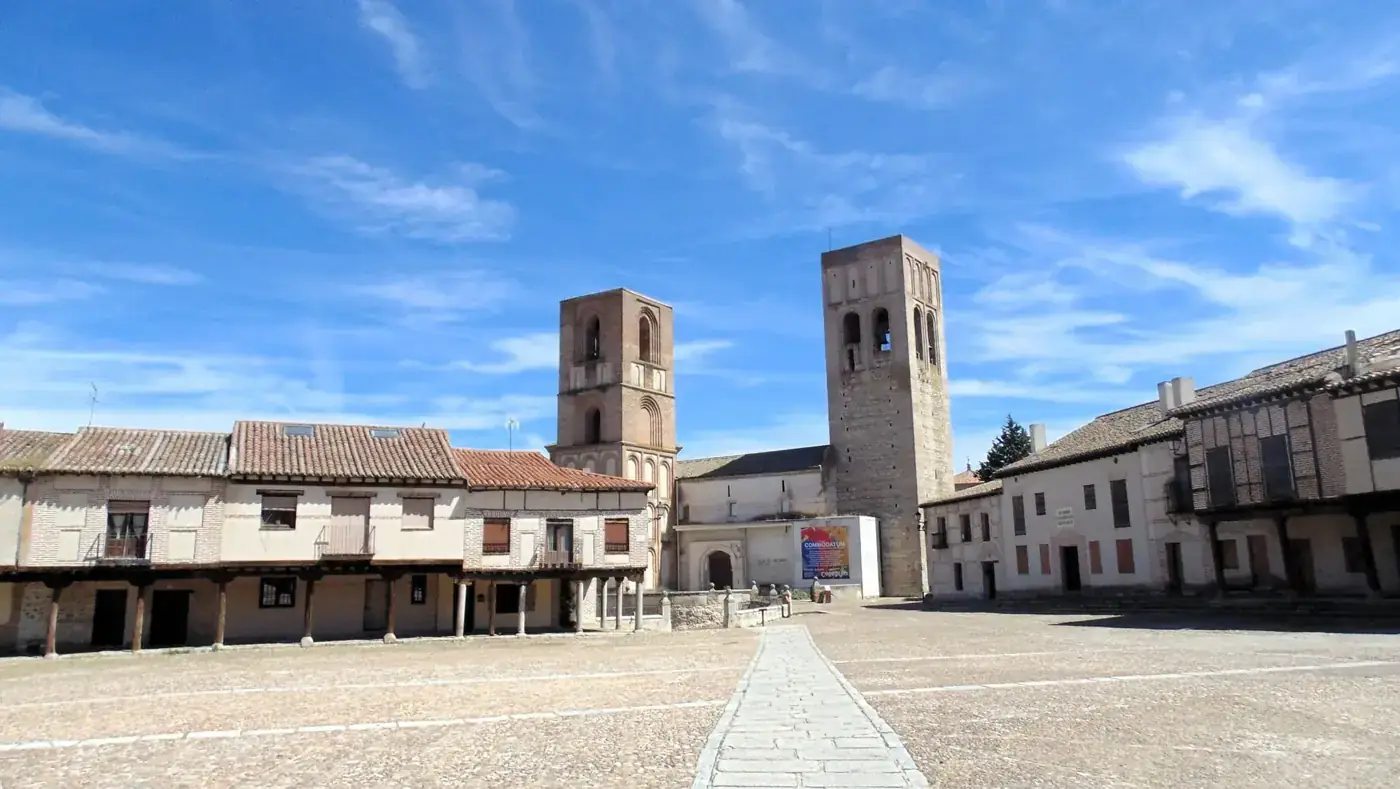 Historic square in Arévalo, Spain with rustic architecture under a clear blue sky.