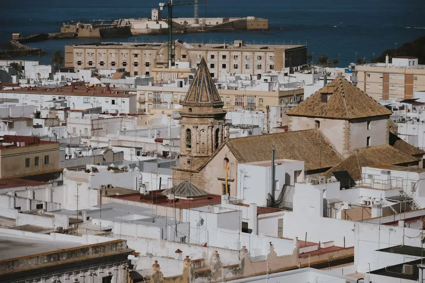 Aerial view of the historic architecture of Cadiz, Spain, showcasing iconic buildings and rooftops.