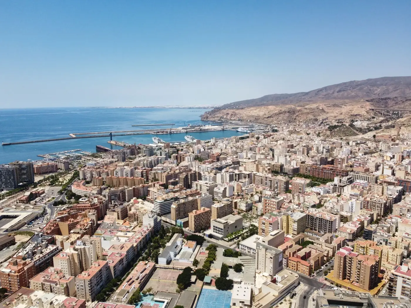 Explore the stunning aerial view of Almería, Spain, showcasing its vibrant cityscape and harbor.