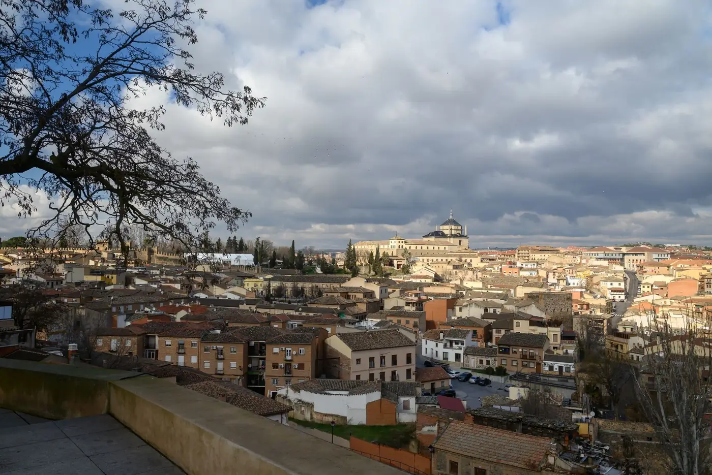 Scenic view of Toledo's historic architecture under a dramatic sky, showcasing the city's unique landscape.