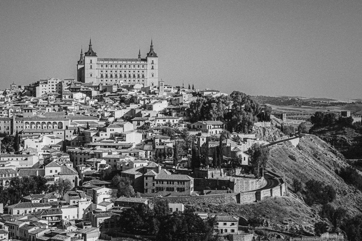A stunning black-and-white cityscape of Toledo, Spain showcasing historic architecture.