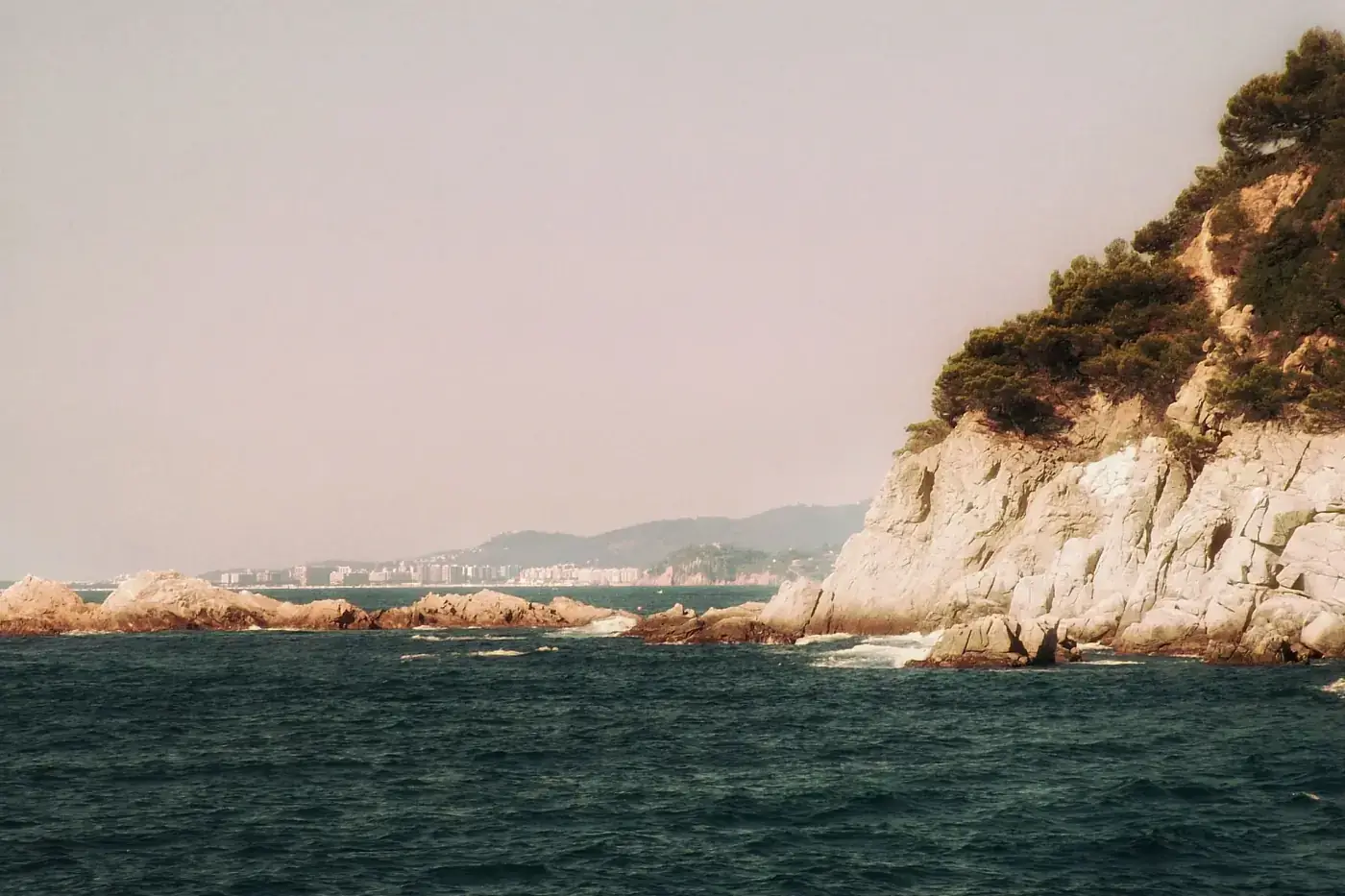 Breathtaking coastal landscape in Catalonia with rocky shoreline and Mediterranean Sea.