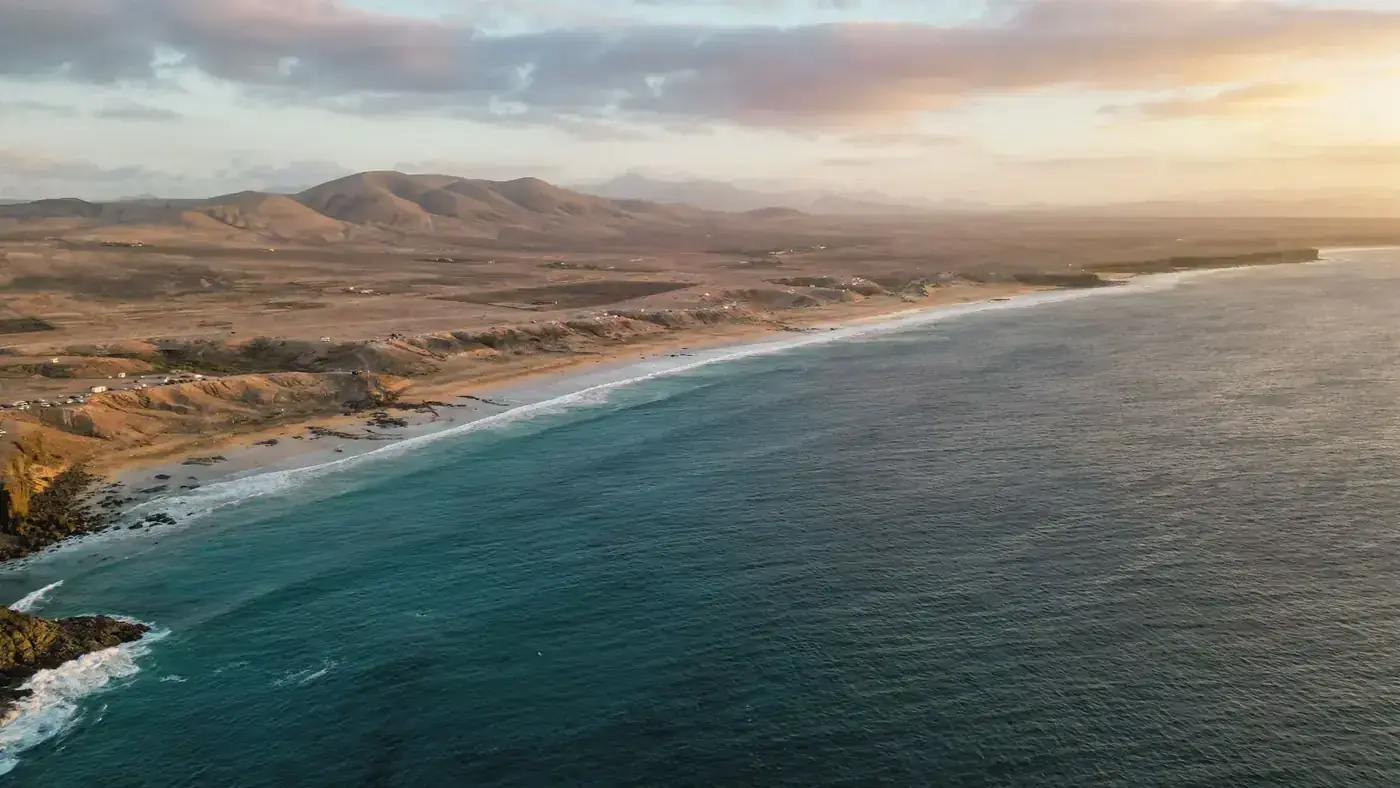 Stunning aerial view of the Canary Islands coastline with mountains and ocean at sunset, Spain.