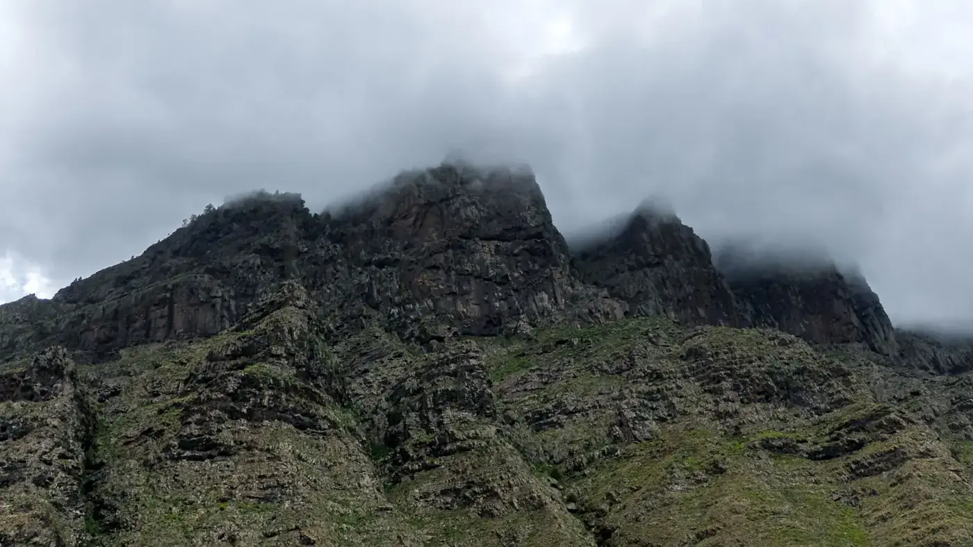 Cloud-covered rugged mountain peaks in the Canary Islands, Spain.