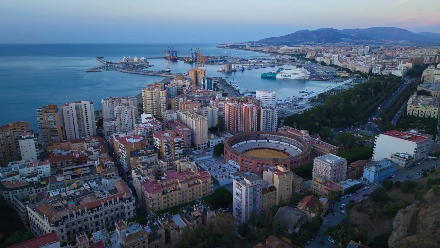 Stunning aerial image of Malaga cityscape, featuring the famous bullring and bustling port.