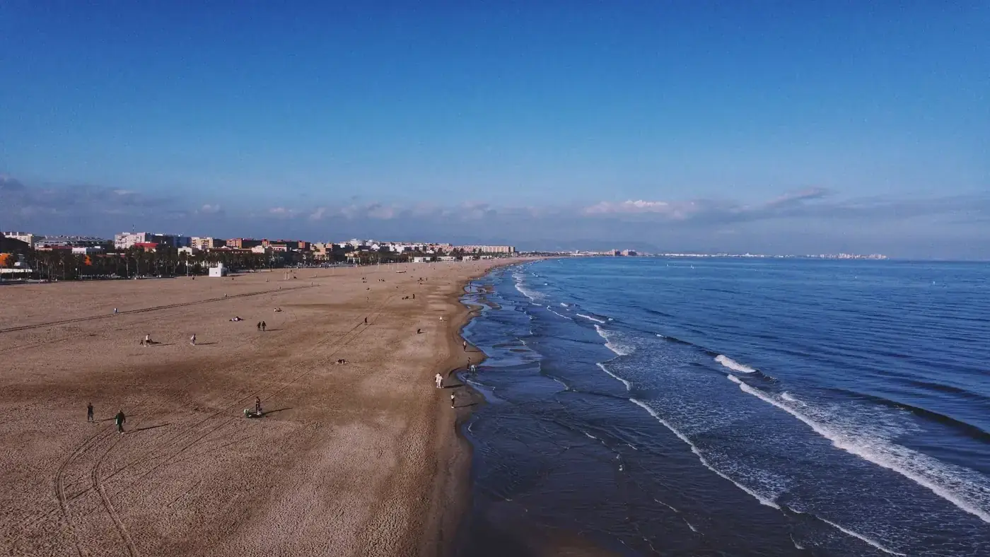 Stunning aerial view of Valencia's coastline, with beach and cityscape, capturing the serene seaside beauty.