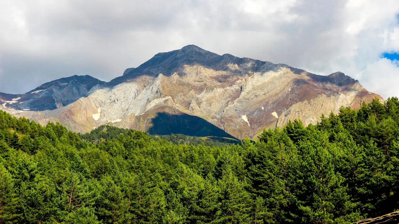 Scenic view of a mountain in Lérida, Spain with lush green forests.