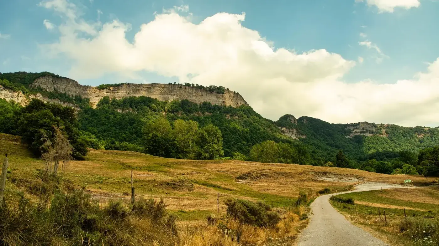 Explore the picturesque landscape of Vall de Sau Collsacabra with its lush greenery and rugged cliffs.