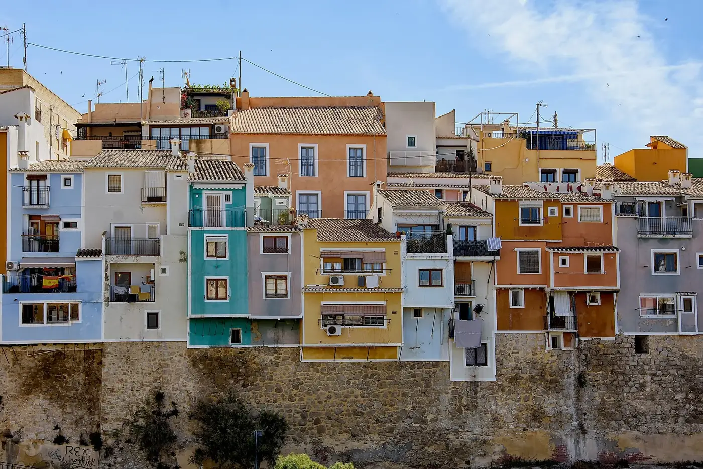 Vibrant houses in Villajoyosa, Spain, showcasing colorful facades and Mediterranean architecture.