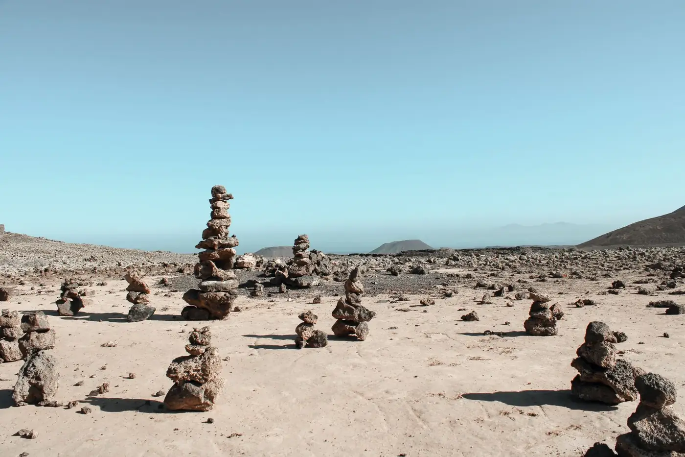 Stone stacks in La Oliva, Spain's desert landscape create a zen and tranquil atmosphere.