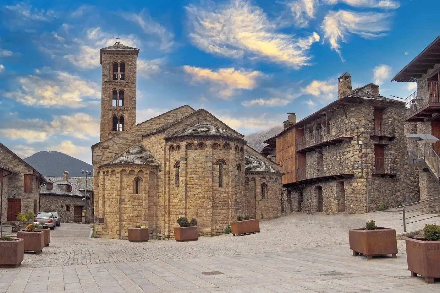 Explore the Romanesque architecture of Pla de l'Ermita, featuring stone structures and a bell tower.