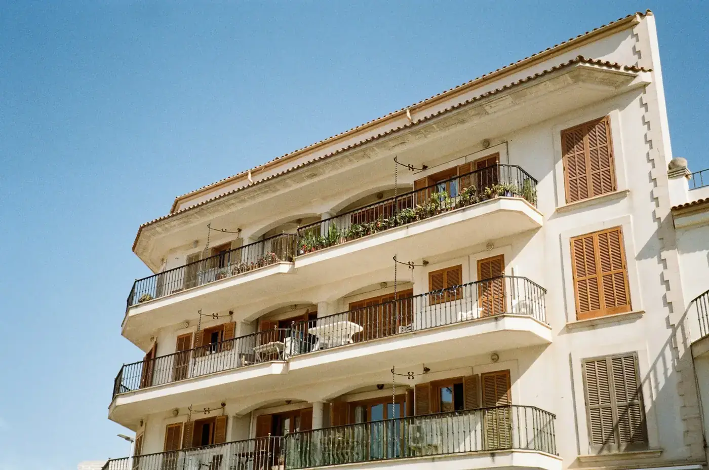 A white building with balconies and balconies on the balconies