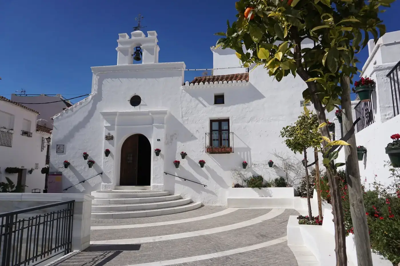 Beautiful white church facade in sunny Mijas, Spain, showcasing classic architecture.