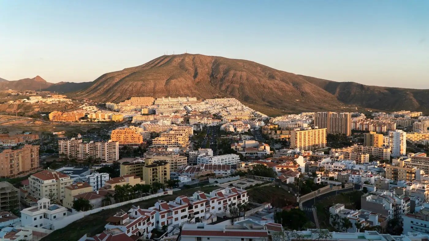 a view of a city with mountains in the background