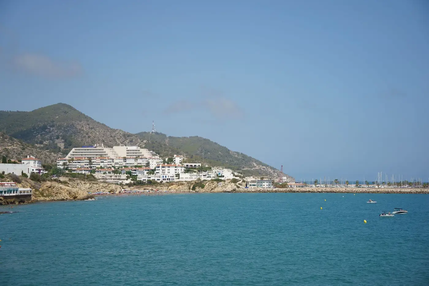 Beautiful coastal view of Sitges, Spain, with modern architecture by the sea.