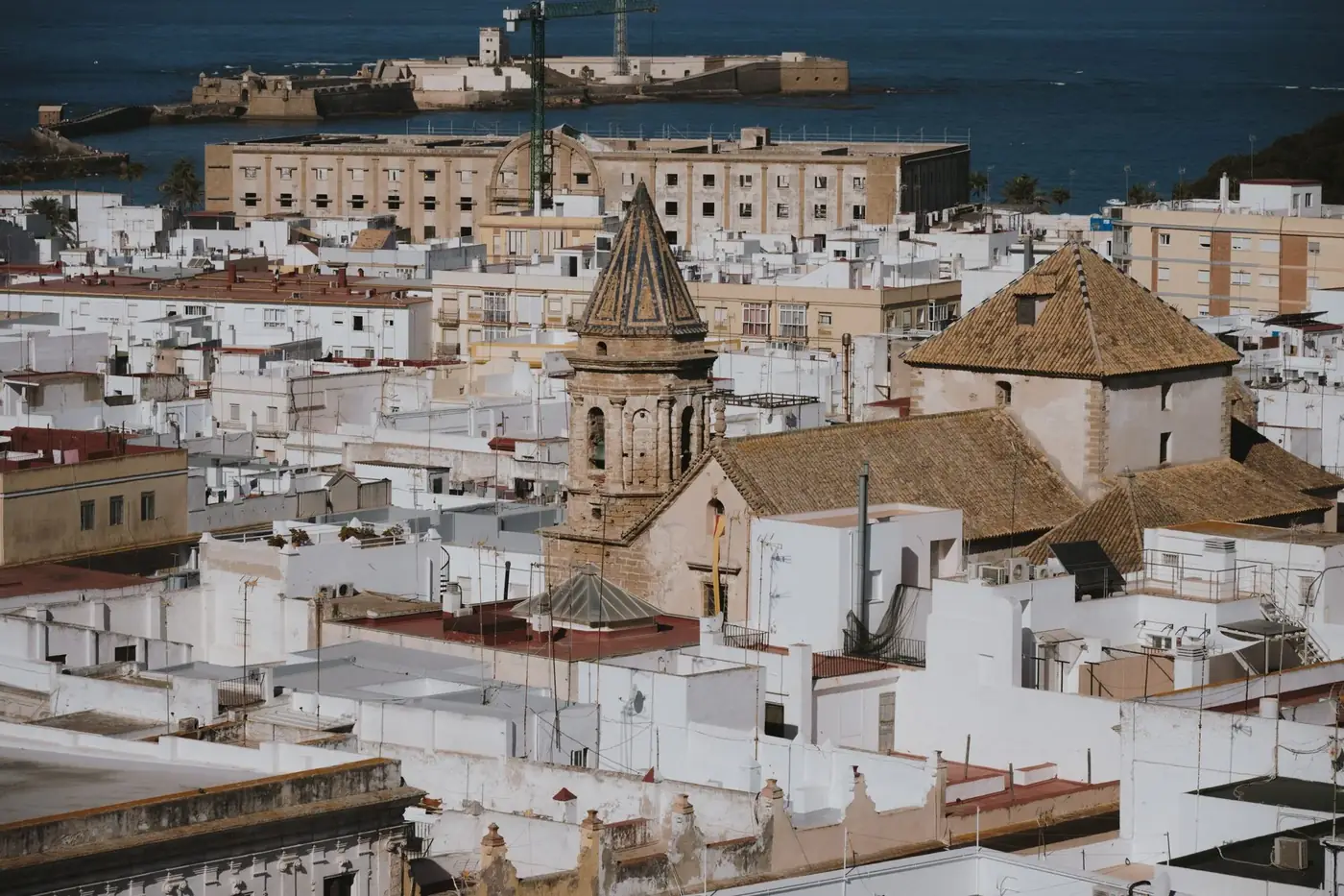 Aerial view of the historic architecture of Cadiz, Spain, showcasing iconic buildings and rooftops.