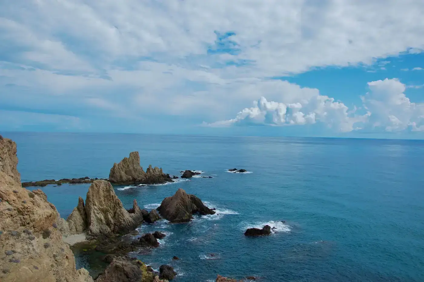 Breathtaking view of rocky seascape at Cabo de Gata in Spain with azure blue sea and sky.