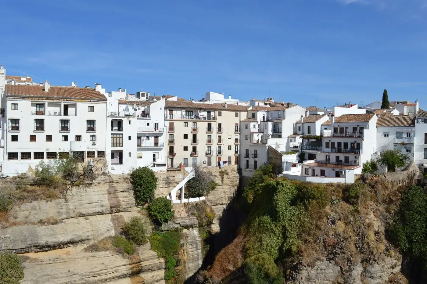 Beautiful whitewashed buildings perched on a cliff in Ronda, Andalusia, Spain. A stunning travel destination.