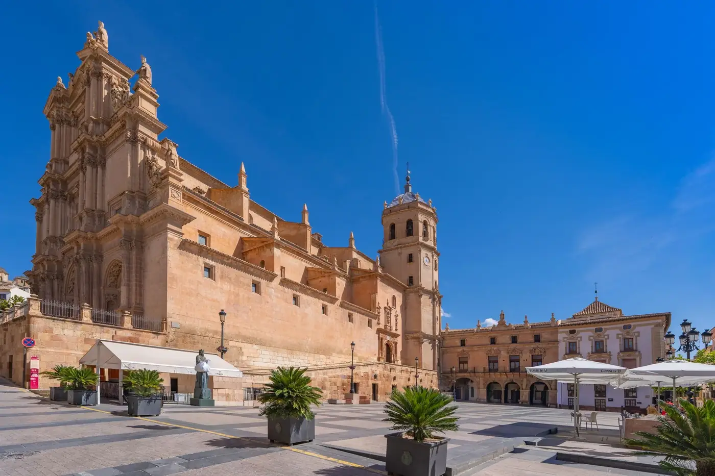 Explore the historic Roman Theatre amidst Cartagena's stunning cityscape under a clear blue sky.