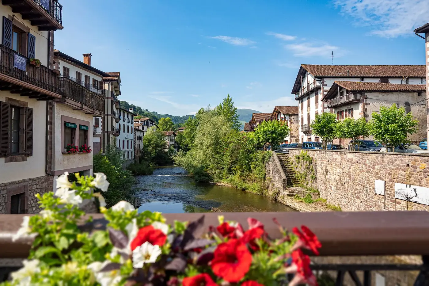Scenic view of Elizondo's historic architecture along a tranquil river.