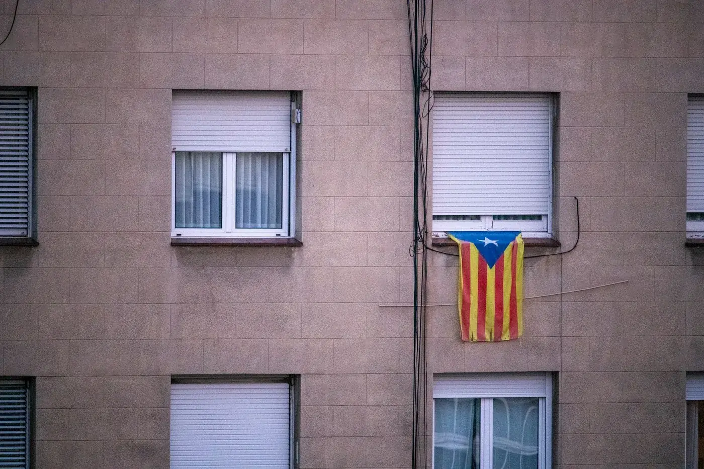 Catalan independence flag displayed outside a residential building in Barcelona.