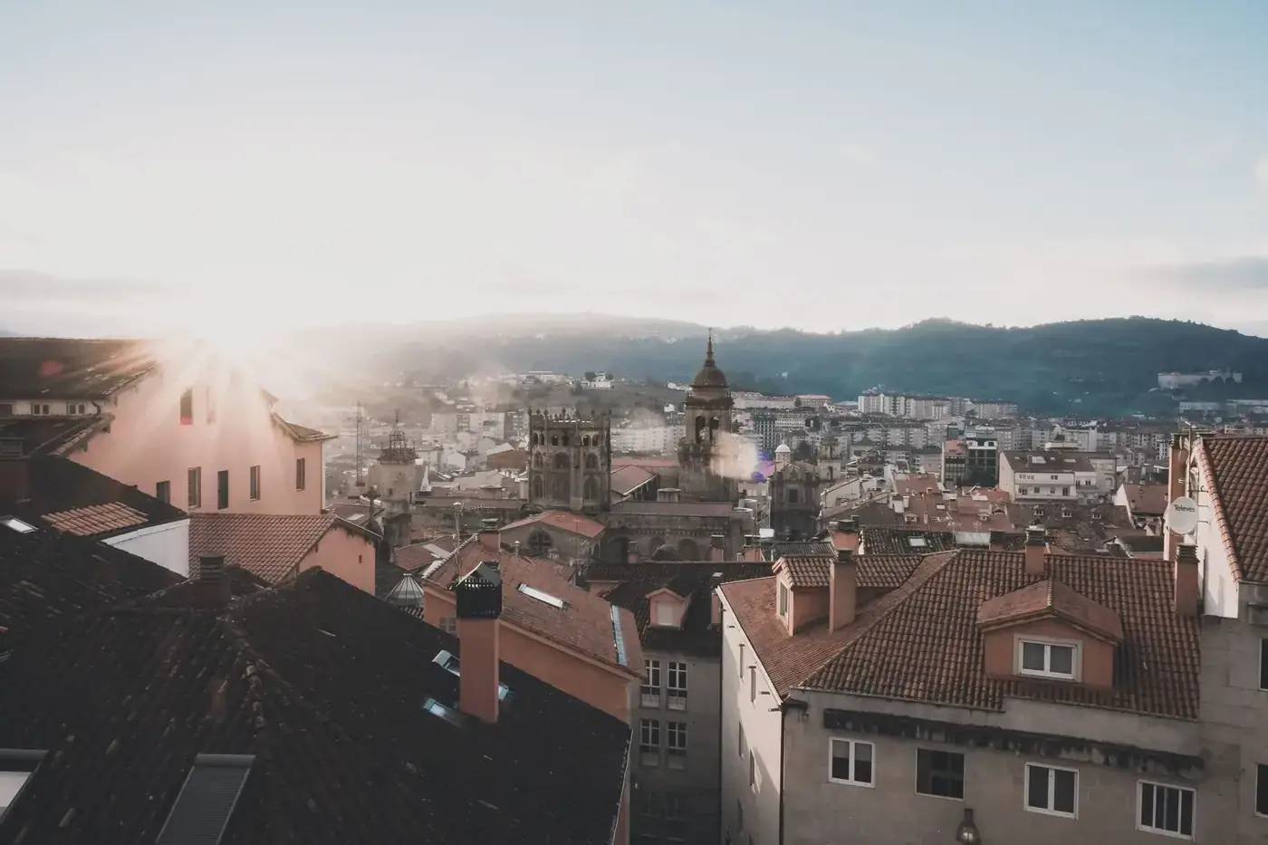 Captivating sunrise over Orense, Spain, highlighting the historic architecture and urban skyline.