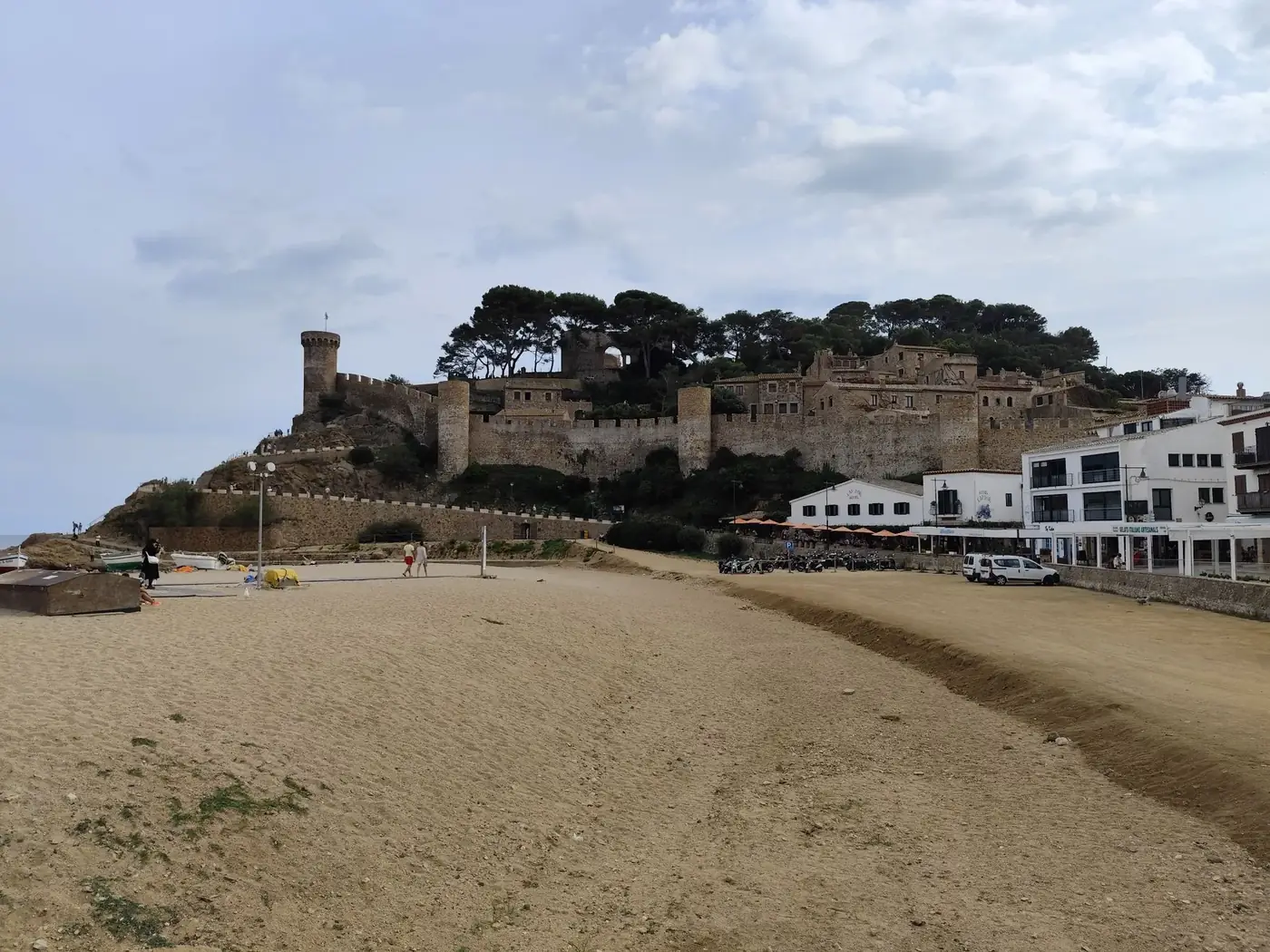 A picturesque view of Tossa de Mar's historic fortress and beach in Catalunya, Spain.