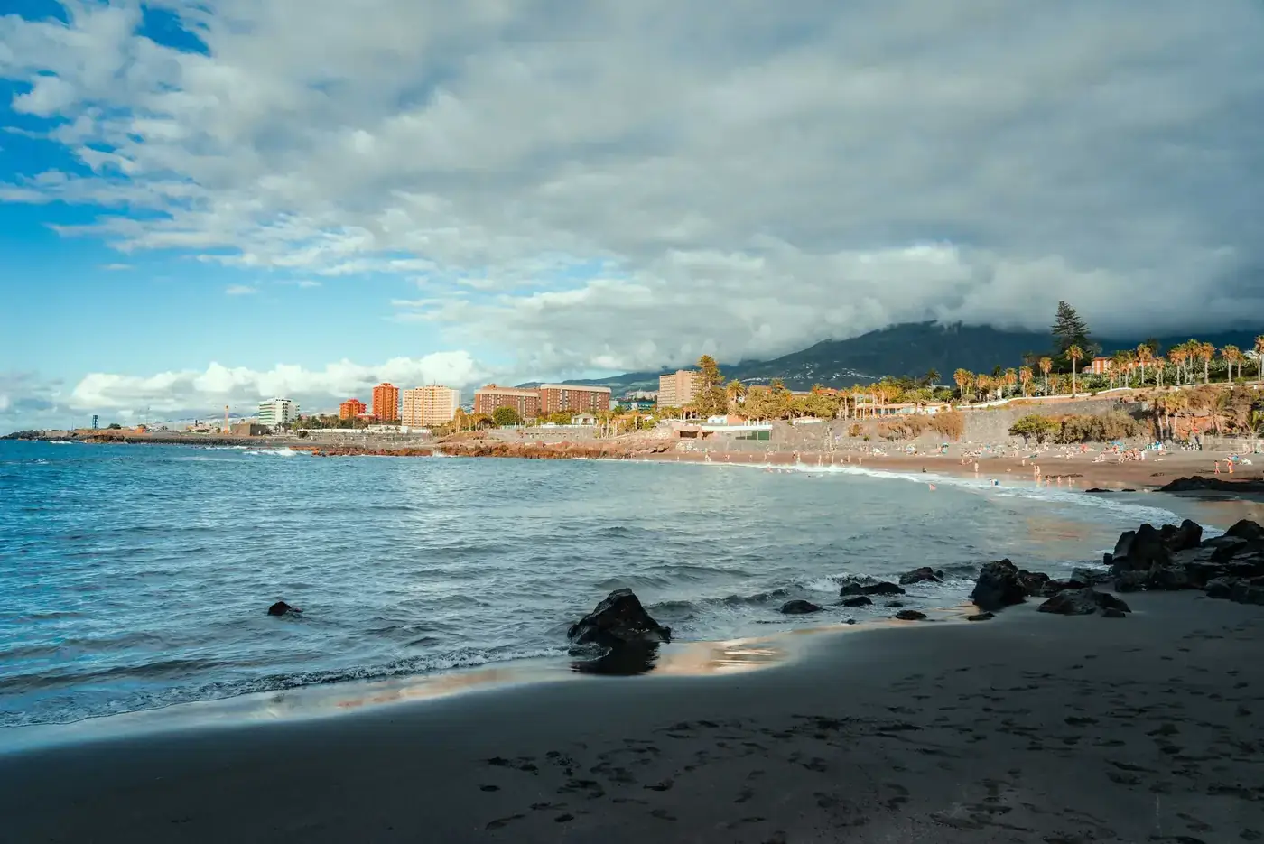 Discover the tranquil shoreline of Puerto de la Cruz in Spain with stunning cityscape and ocean views.