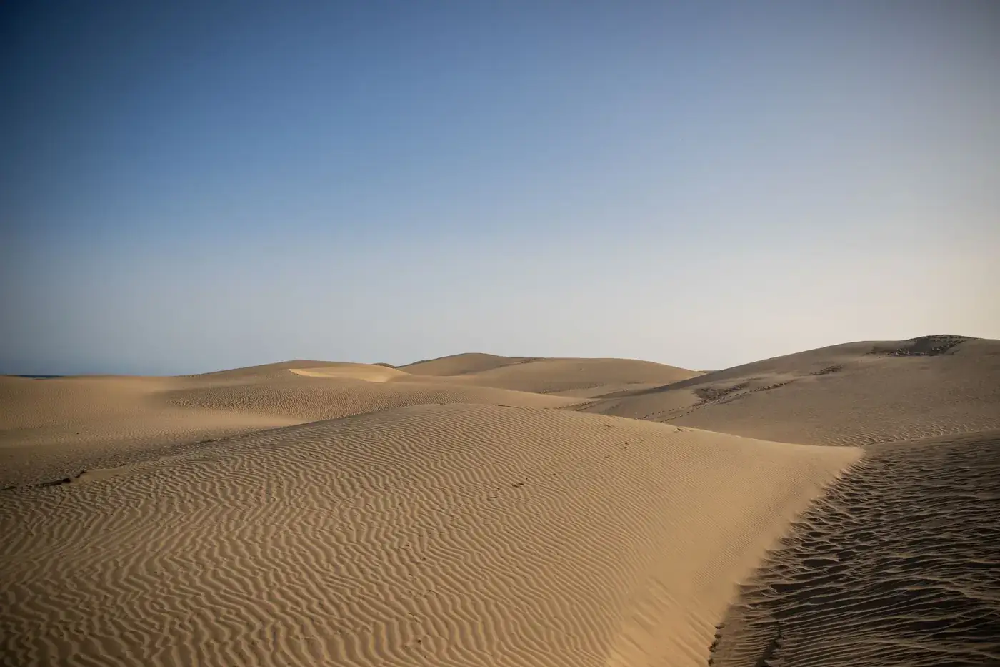 Serene view of the vast sand dunes at Maspalomas, a natural wonder in Gran Canaria, Spain.