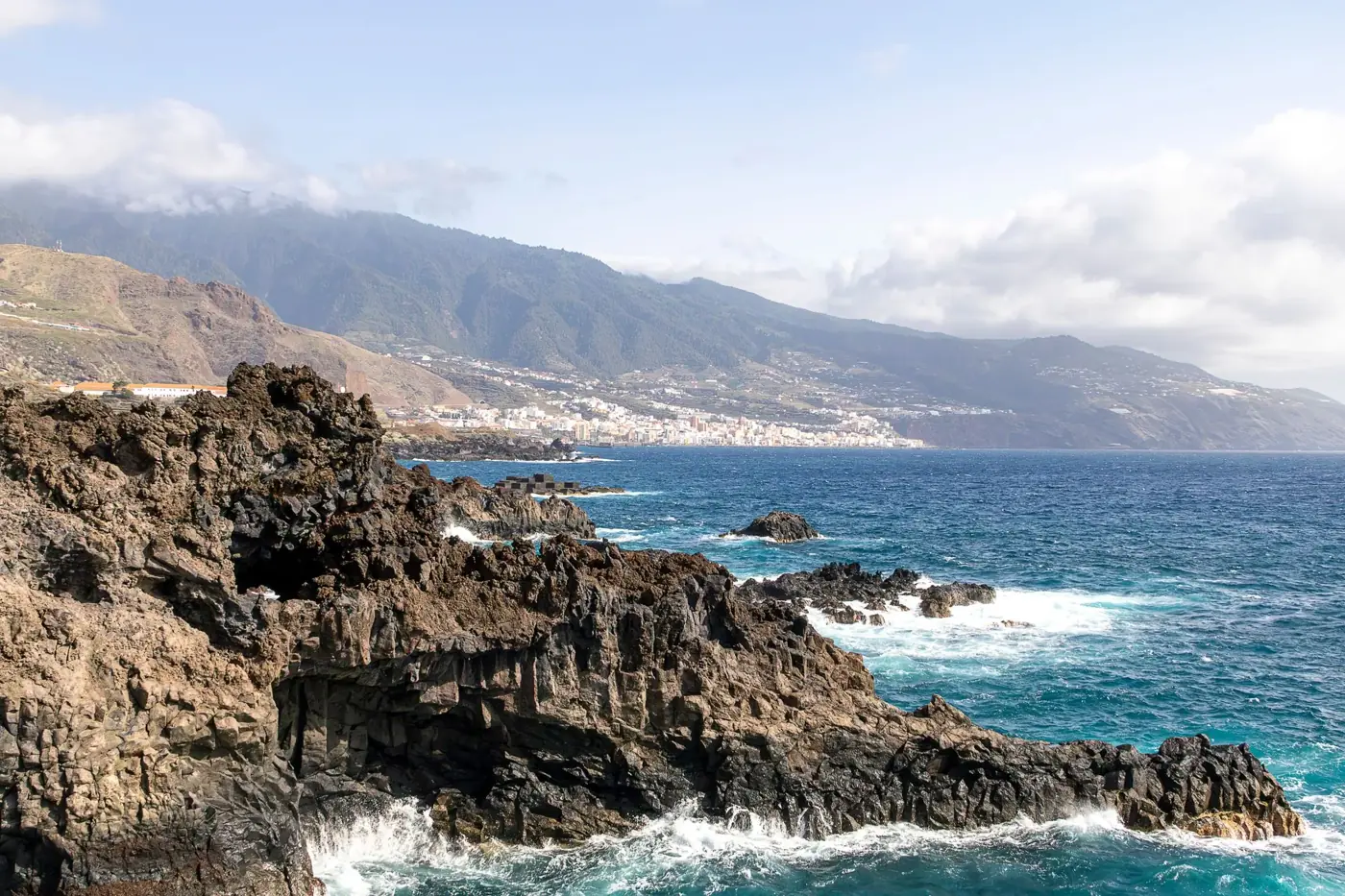 Explore the rugged coastline of La Palma with striking mountain and ocean views.