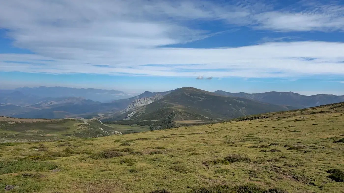 A breathtaking view of mountains and valleys under a blue sky in Castilla y León, Spain.