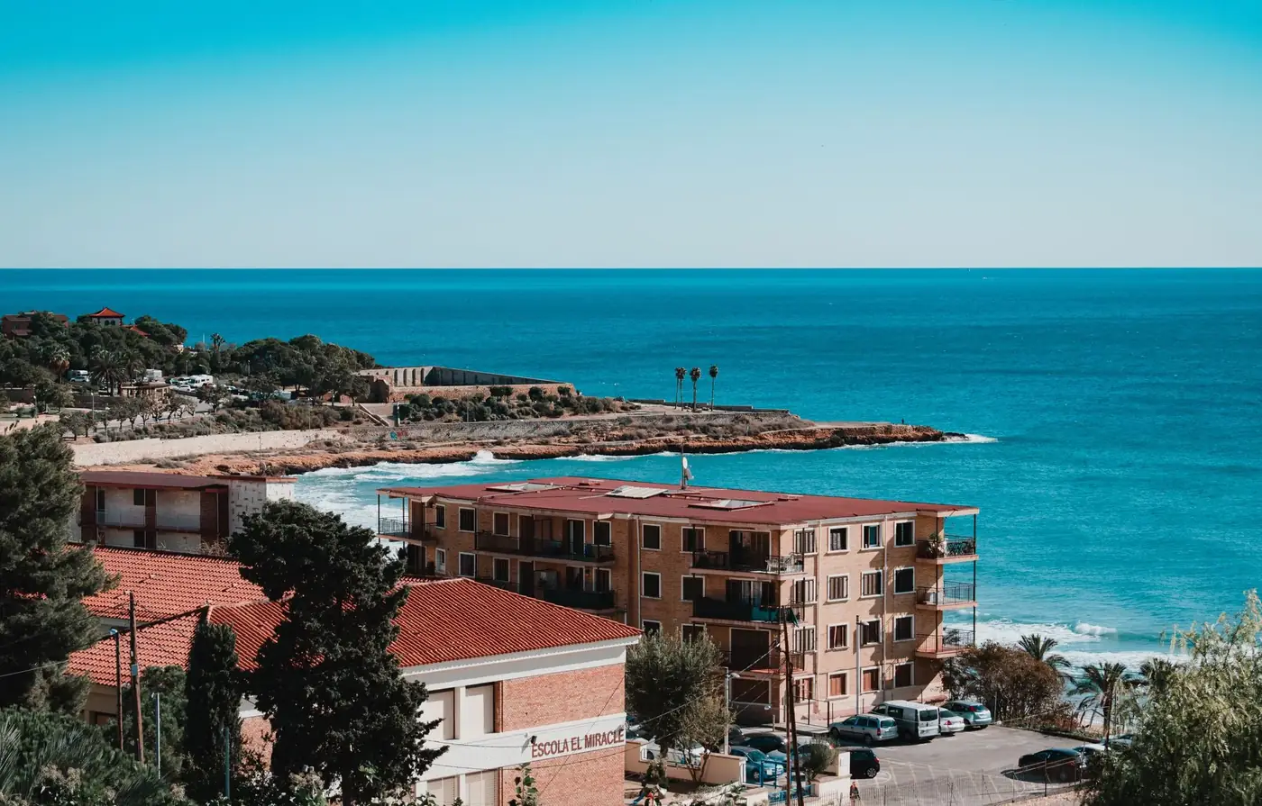 Aerial view of Tarragona's stunning coastline with clear blue skies and Mediterranean Sea.