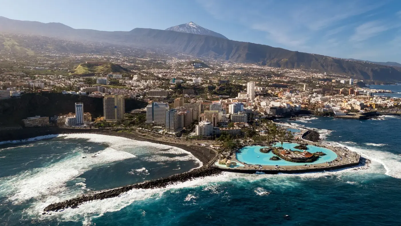 Stunning aerial view of Puerto de la Cruz with Mount Teide in the background.