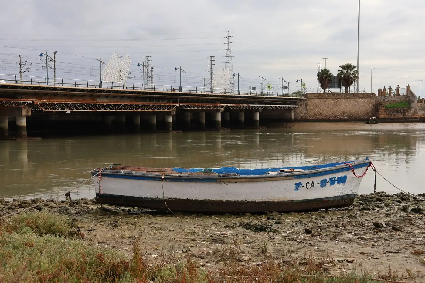 Tranquil boat scene by the bridge in El Puerto de Santa María, Spain.