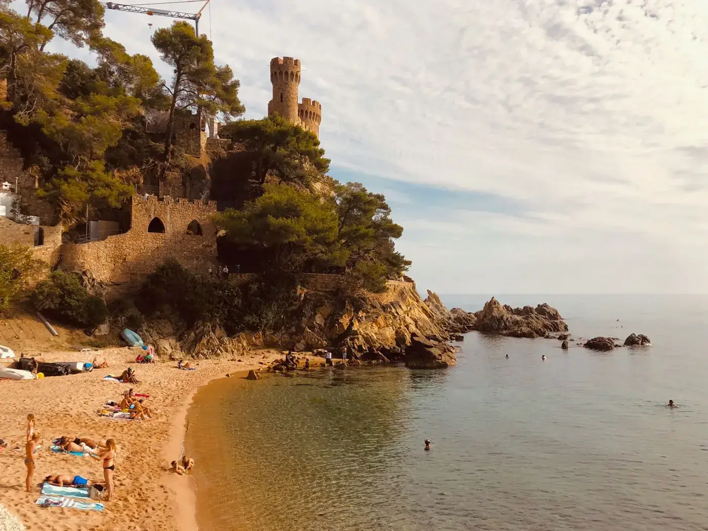 Scenic view of a medieval castle by the beach in Catalonia, Spain.