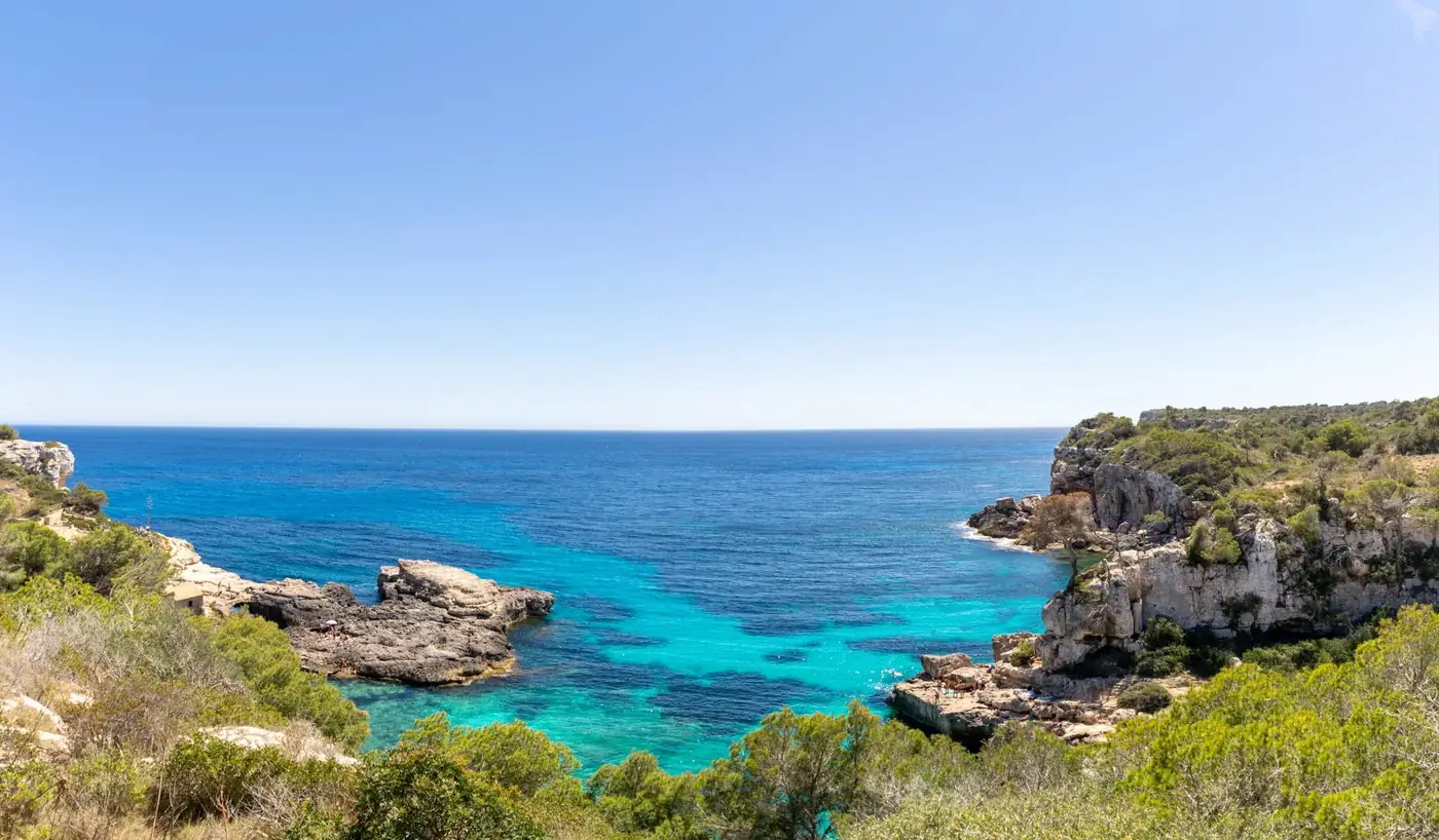 Breathtaking view of Sant Antoni de Portmany's turquoise sea and cliffs.