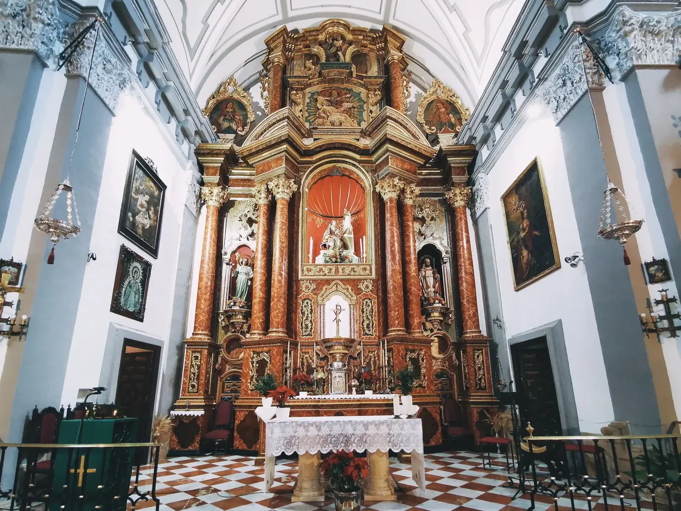 Intricately designed altar at Santa Cecilia Church, Ronda, Spain, showcasing religious art and architecture.