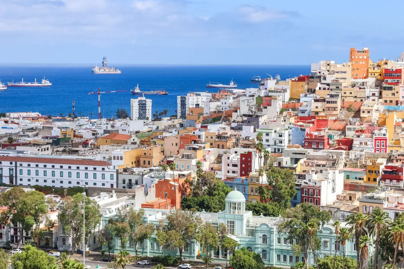 Aerial view of vibrant Las Palmas de Gran Canaria with ships in the Atlantic Ocean.