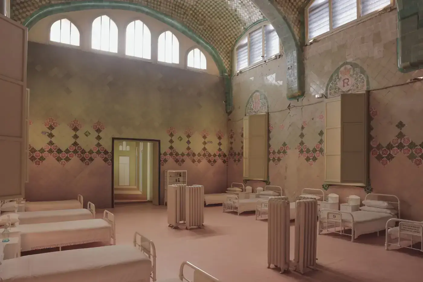 Interior of a historical hospital ward in Barcelona with ornate tiled walls.